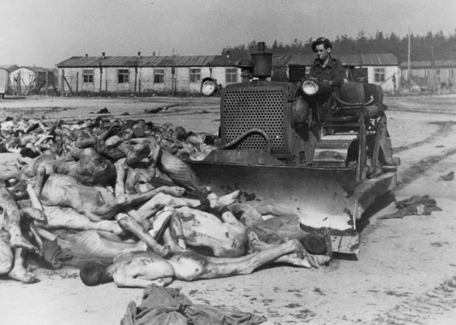 Un Bulldozer del Ejército Británico empuja cuerpos a una fosa común en Belsen, 19 de abril 1945