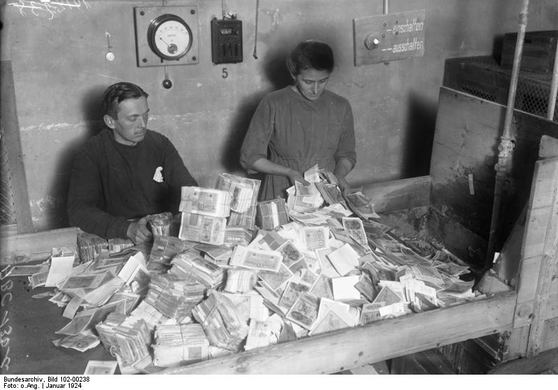 Funcionarios alemanes recolectando el papel moneda devaluado, enero de 1924