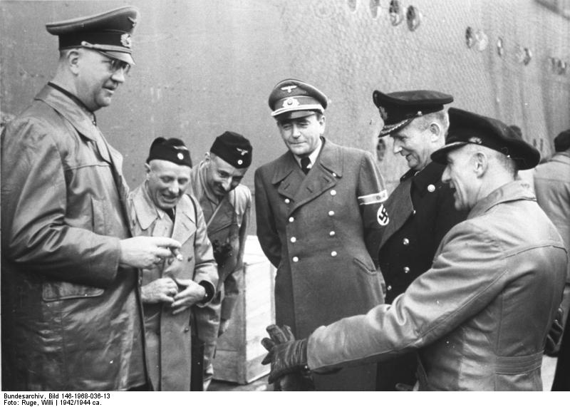 El general Friedrich Fromm, dos marineros, Albert Speer, el gran almirante Karl Doenitz y Hans Kehrl frente al casco de un barco en 1942